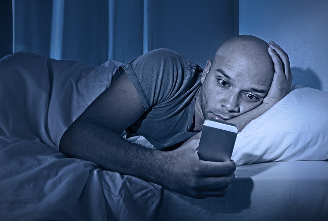 man using cell phone late night