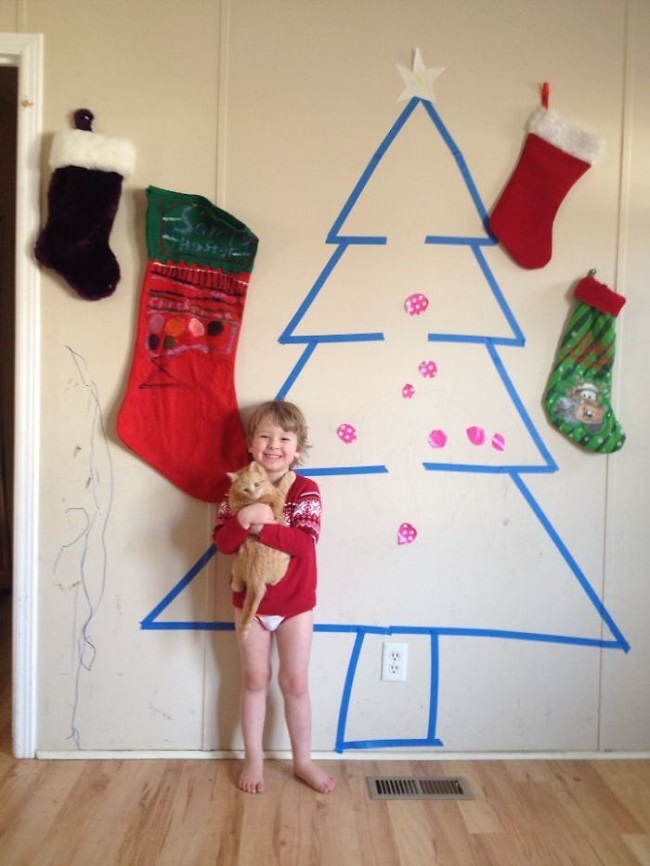 Christmas tree on the wall of the house