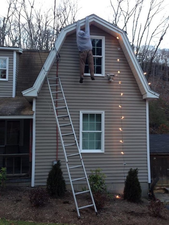 dummy being erected on house as part of Christmas celebrations