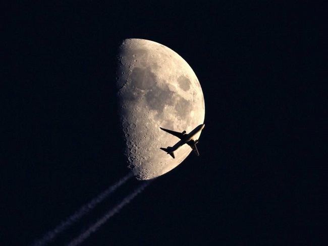 Is this plane almost missing the moon.