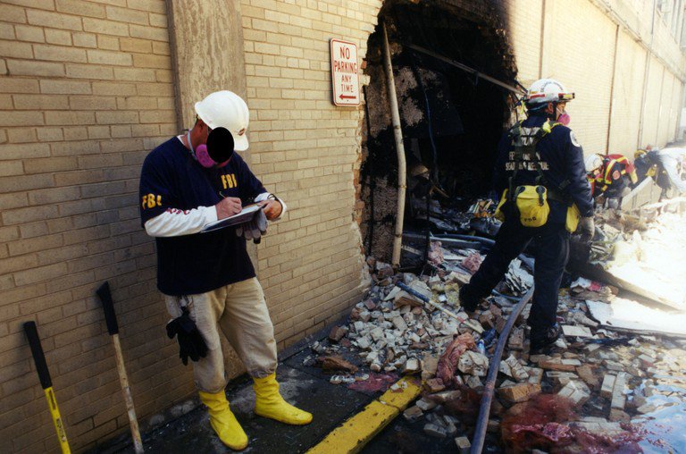 FBI personnel noting down the damage