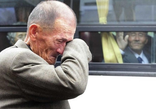 North Korean man waves to South Korean relative