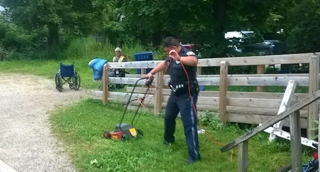 Police officers help disabled man mow his lawn in Michigan