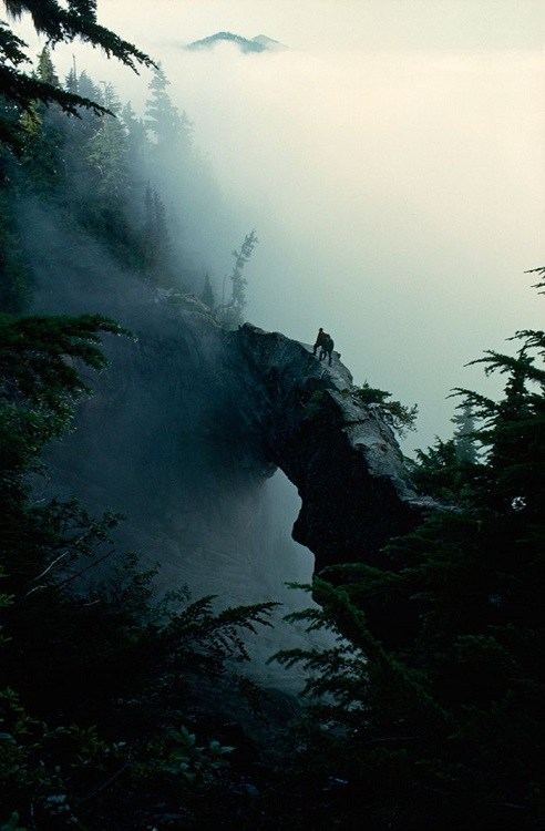 hikers standing a top a natural rock