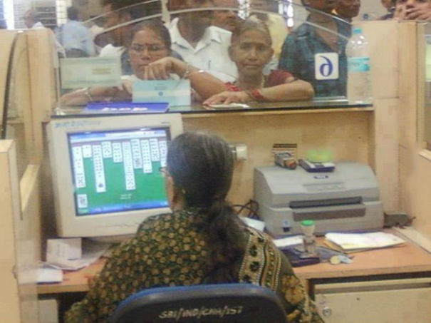 woman clerk playing cards on pc.