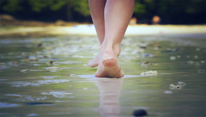 Walking barefoot on ground 