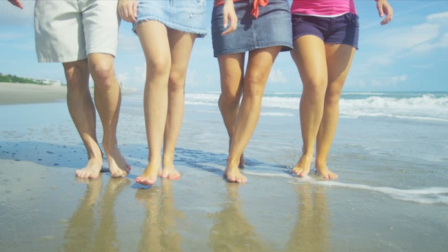 Walking barefoot on the beach 