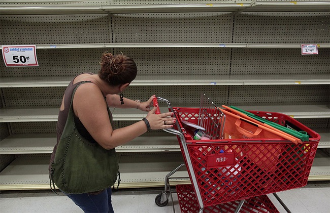 Woman looks at empty shelves