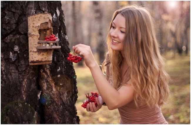 Girl feeding the birds.