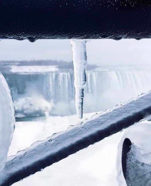 The picture shows an icy railings with icy teeth