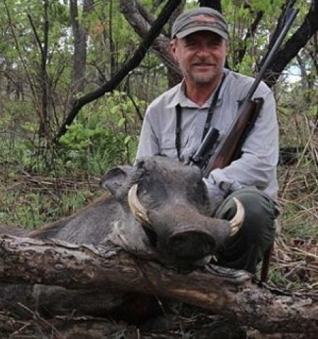 hunter posing with killed animals