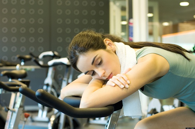 female taking rest on gym