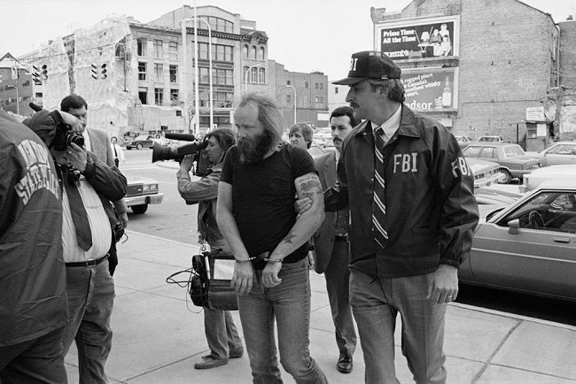 FBI agent cuffs and takes away a Hells Angels member