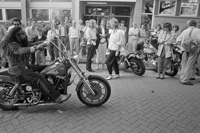 Onlookers watch curiously at bikers