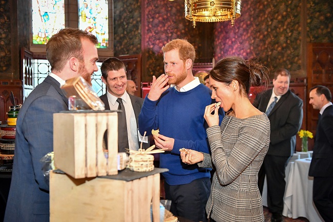 Prince Harry and Meghan Markle eating cake