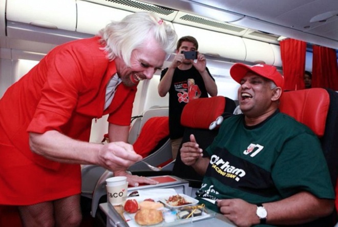 Richard Branson serving in flight