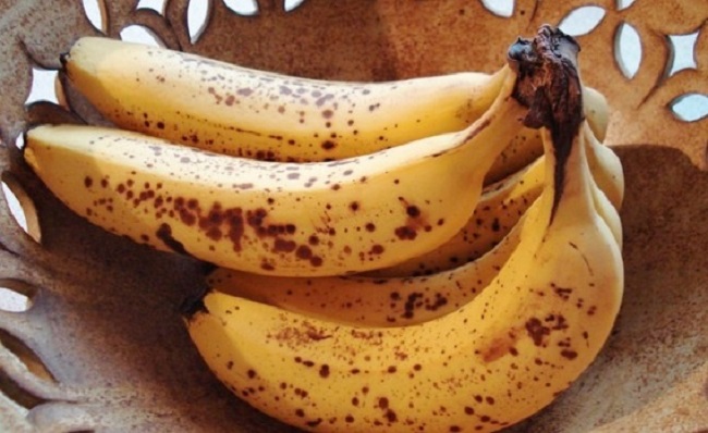 Yellow bananas with brown spots