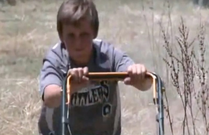 boy mowing lawn